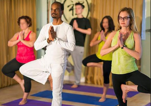 Yoga teacher guiding students in Rishikesh during 200 hour yoga teacher training at East Meets West Yog Academy